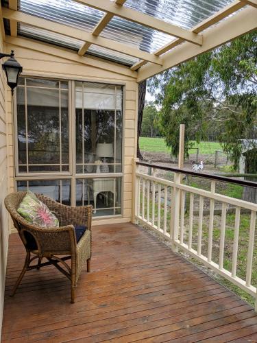 a screened in porch with a chair and a window at Nicholson BnB and Arts Centre in Nicholson