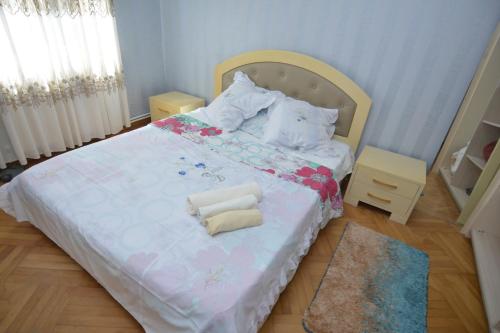 a bedroom with a bed with two towels on it at vip ozurgeti in Ozurgetʼi