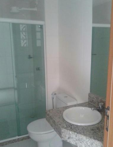 a bathroom with a toilet and a sink at Imbassaí Solaris Ap Beach in Imbassai
