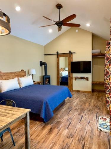 a bedroom with a bed and a ceiling fan at Baycrest Lodge in Homer