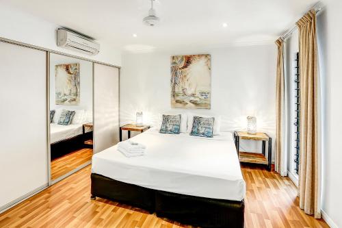 a bedroom with a large white bed in a room at Cascade Gardens in Cairns