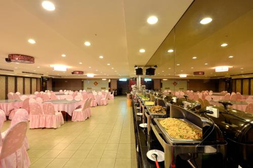 a large banquet hall with pink tables and chairs at Ever Delightful Business Hotel in Chiayi City