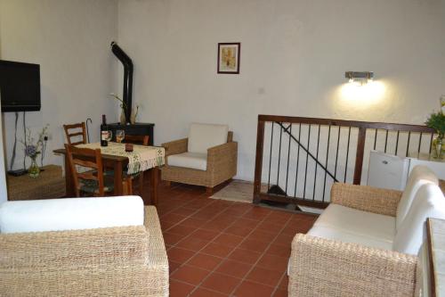 a living room with couches and a table and chairs at Irene's House in Kakopetria
