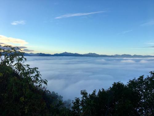 a view of a sea of clouds in the sky at Baycrest Lodge in Homer