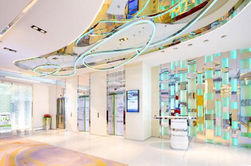 a lobby with a colorful wall of glass at iclub To Kwa Wan Hotel in Hong Kong