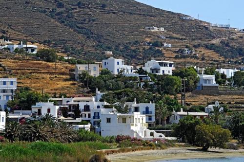 a village on a hill with white houses at Akrogiali Hotel in Agios Sostis