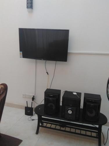 a table with two speakers and a flat screen tv at VILLA ARIANNA in Wattala