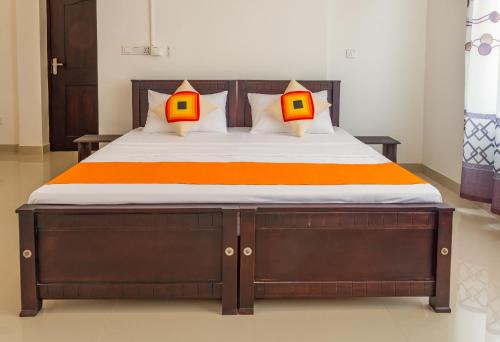 a bedroom with a bed with two lamps on it at Harry Inn in Negombo
