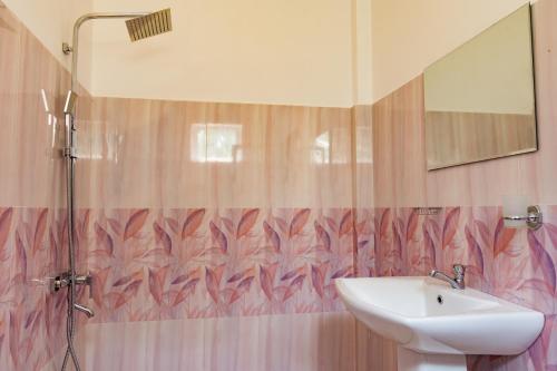 a bathroom with a sink and a shower at Harry Inn in Negombo