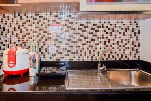 a kitchen counter with a sink and a mixer at Spacious 2BR GP Plaza Apartment By Travelio in Jakarta