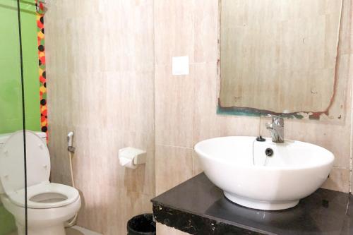 a bathroom with a sink and a toilet at RedDoorz near Pantai Pede in Labuan Bajo