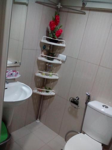 a bathroom with a toilet and a sink at StayCation Dream CondoTel in Manila
