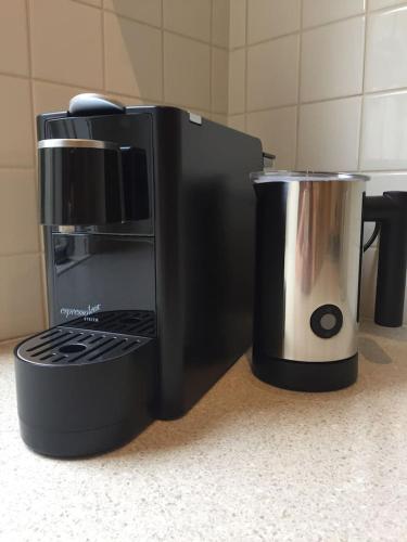 a coffee maker sitting on a counter next to a cup at Healesville Cottage in Healesville