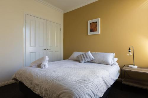 a bedroom with a bed with two pillows on it at Healesville Cottage in Healesville