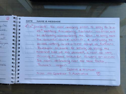 a notebook with handwriting on the pages at Ironstone Romantic Couples Retreat in Halls Gap