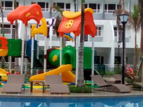 a water park with a slide in a pool at StayCation Dream CondoTel in Manila