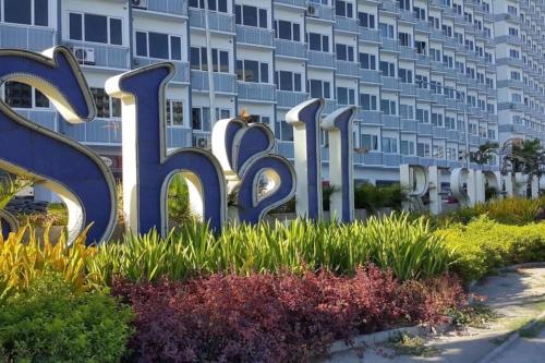 a large hotel sign in front of a building at StayCation Dream CondoTel in Manila
