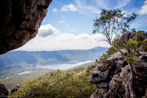 a view of a lake from a rock cliff at Bushland in Halls Gap