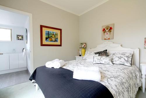 a bedroom with a bed with towels on it at Nicholson BnB and Arts Centre in Nicholson