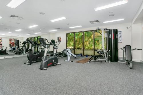 a gym with treadmills and elliptical machines at Private Apartments in the Temple Beachfront Resort Palm Cove in Palm Cove