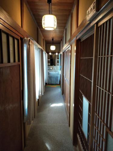 a hallway of a prison cell with a hallwayngthngthngthngthngthngthngth at Izu Hokkawa Seaside Guesthouse 伊豆北川の家 in Higashiizu