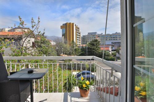 a balcony with a table and a view of a city at Marinero Apartments in Budva