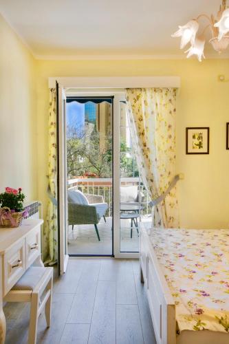 a bedroom with a bed and a sliding glass door at Marinero Apartments in Budva