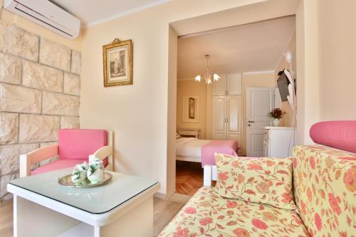 a living room with a couch and a table at Marinero Apartments in Budva