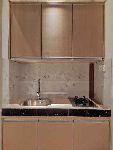 a kitchen with a sink and a stove at The Surya Kuta Villa in Kuta