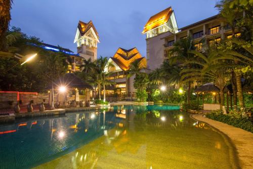 a pool in front of a hotel at night at Dongguan Richwood Garden Hotel in Dongguan