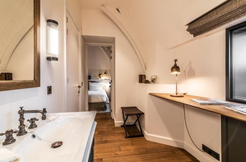 a bathroom with a sink and a mirror at 1898 The Post in Ghent
