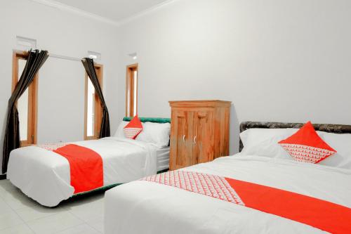 מיטה או מיטות בחדר ב-OYO 605 Queen Homestay