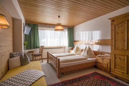 a hotel room with a bed and a desk at Appartements Bachler in Brixen im Thale
