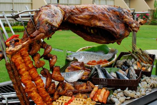 a bunch of different types of food on a grill at PULSE GRANDE Hotel Putrajaya in Putrajaya