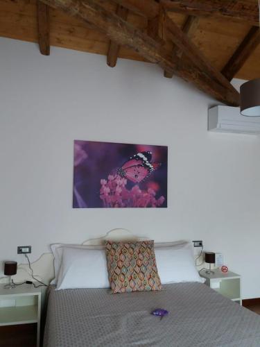 a bedroom with a bed with a picture on the wall at LOCANDA RIGHETTO in Quinto di Treviso