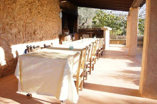 a row of tables and chairs in a room at Finca Agroturismo Sa Cova den Borino in Campos