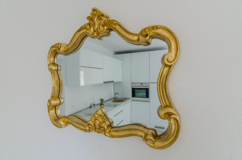 a gold mirror hanging on a wall at Vila Maria in Râşnov