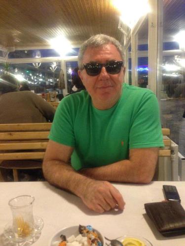 a man sitting at a table with a plate of food at Guest House Tikhiy Dvorik in Baku