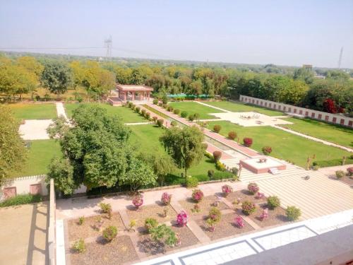 an aerial view of a park with flowers and trees at Umaid Palace - A Lakeside Resort - 25 minutes from Mehandipur Balaji - 20 minutes from Chand Baori Stepwell Abhaneri & 40 minutes from Bhangarh Fort in Dubbī