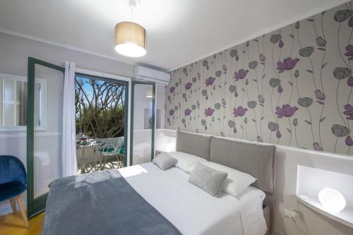 a bedroom with a white bed and a balcony at Casa Giovannina in Conca dei Marini