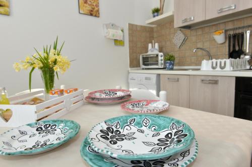 a kitchen with four plates on a table at Sweet Home Positano in Positano
