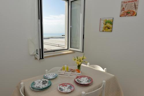 a table with plates on it with a window at Sweet Home Positano in Positano