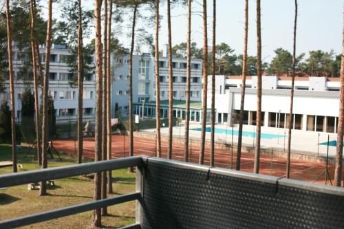 a view of a building from a fence with a train at Heaven Apartament in Pogorzelica