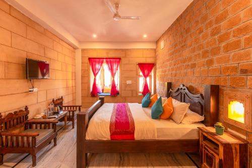 a bedroom with a bed and a brick wall at Boutique Helsinki in Jaisalmer