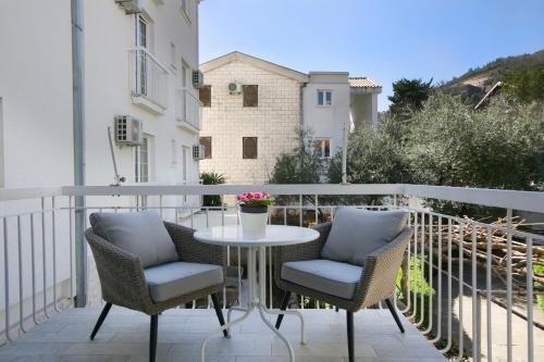 a patio with two chairs and a table on a balcony at Marinero Apartments in Budva