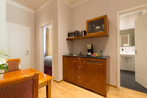 a room with a kitchen with a counter top at Batschari Palais Baden-Baden in Baden-Baden