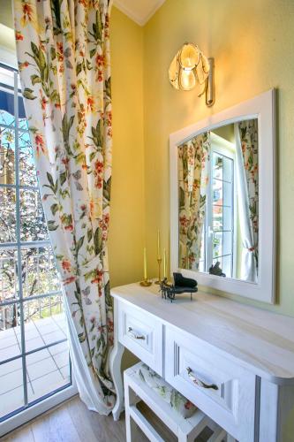 a bathroom with a white vanity and a mirror at Marinero Apartments in Budva