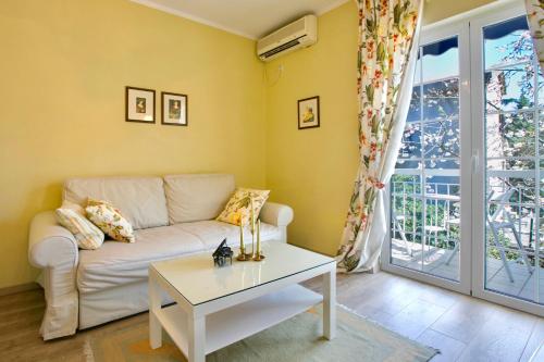 a living room with a couch and a table at Marinero Apartments in Budva