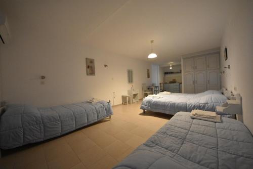 a bedroom with two beds and a room with at Panos Studios in Masouri