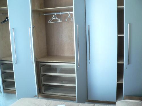 a walk in closet with white doors and shelves at Liège centre 13 Quai Godefroid Kurth POUR 2 PERS à 25 min gare Guillemins in Liège